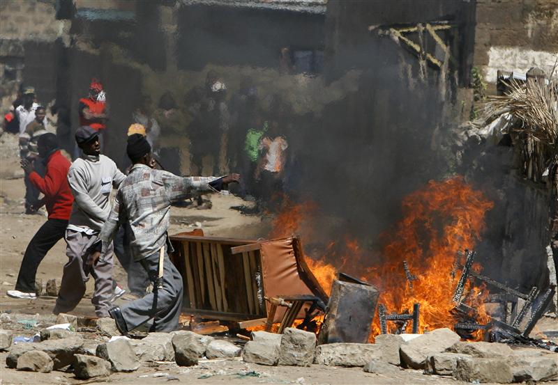 Kikuyu tribe members burn properties belonging to the Luo tribe during ethnic clashes in Naivasha town